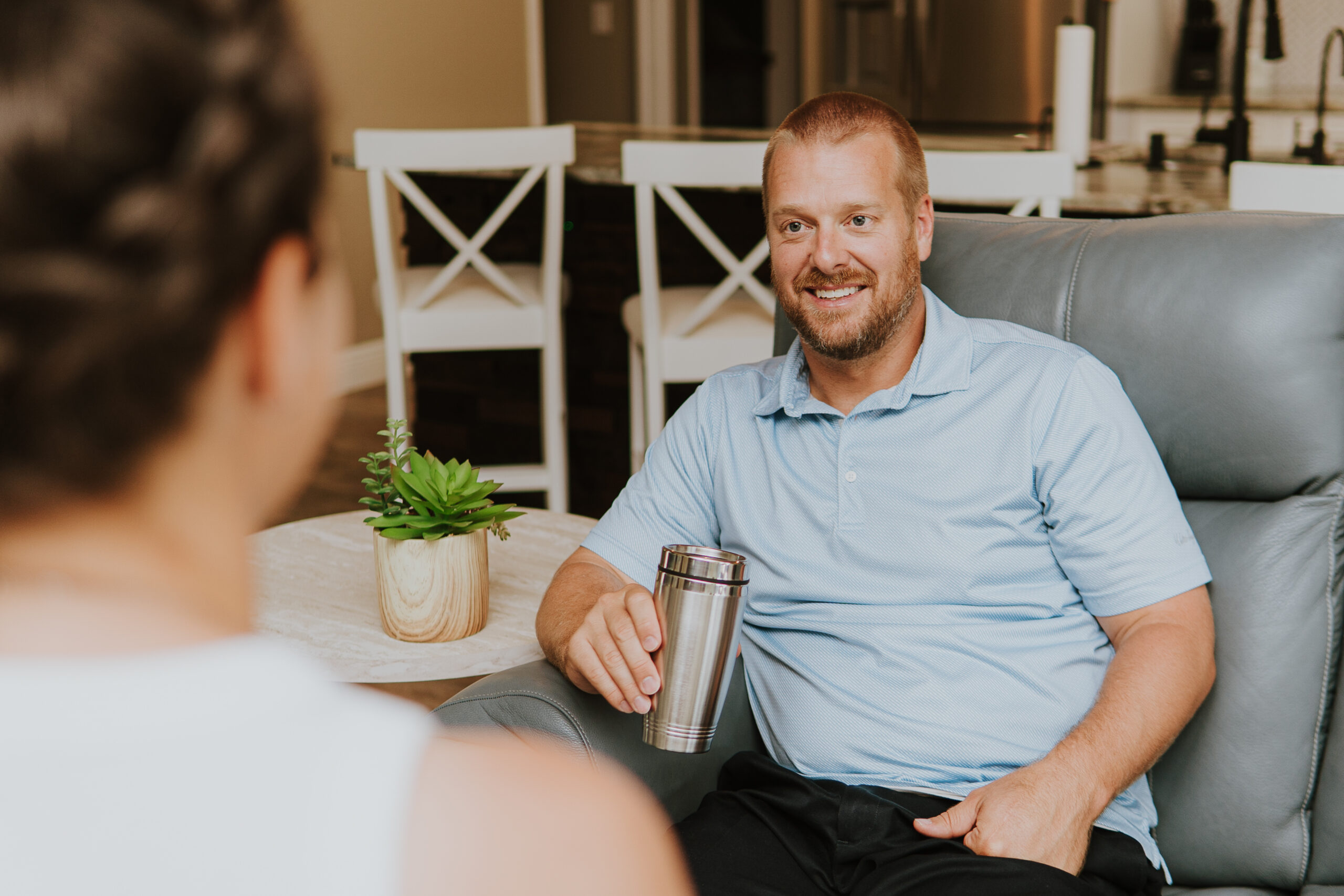 Justin Boyd sitting on a couch during a client conversation