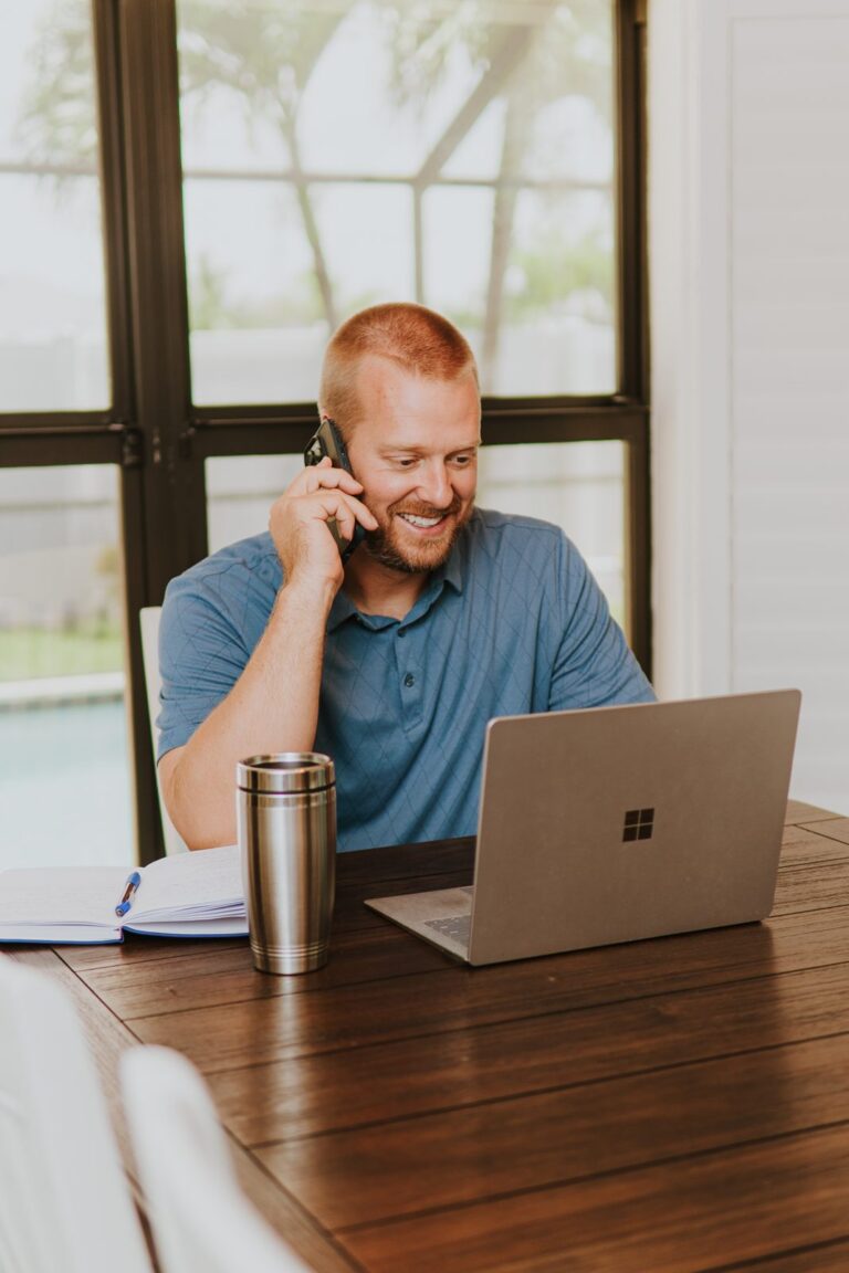 Justin Boyd, fractional CFO at Cash Flow Copilot, on a client call at his desk